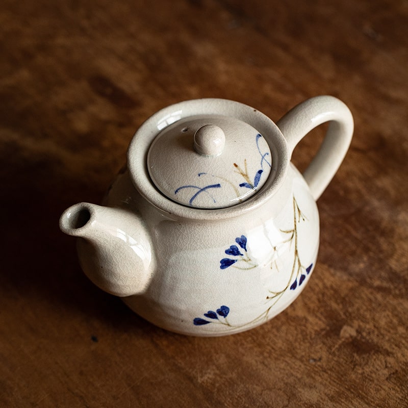 Minimalist handcrafted teapot showcasing elegant cream glaze.