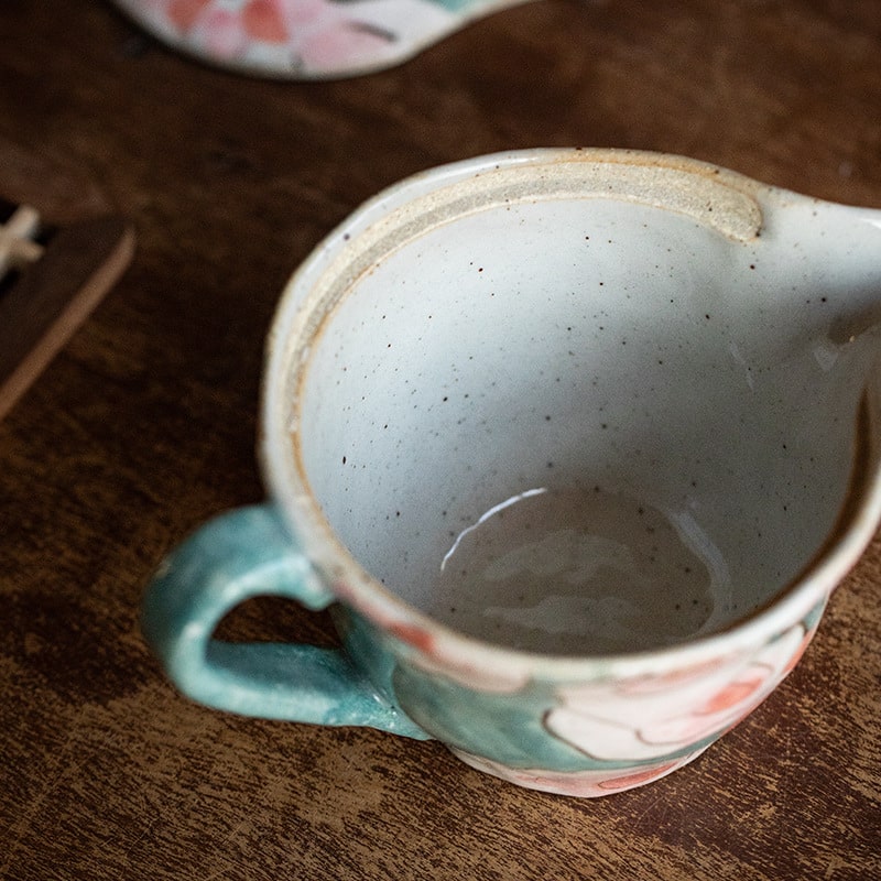 Open ceramic teapot showcasing inner glaze details