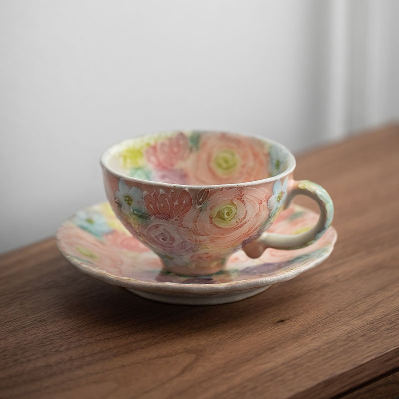 Close-up of a Seto ware ceramic cup showcasing vibrant flower patterns