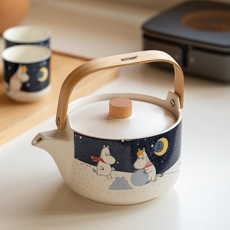 Moomin tea set in soft yellow tones, perfect for cozy tea moments.