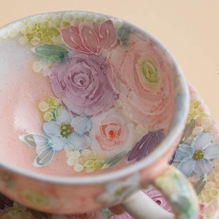 Close-up of a Seto ware ceramic cup showcasing vibrant flower patterns