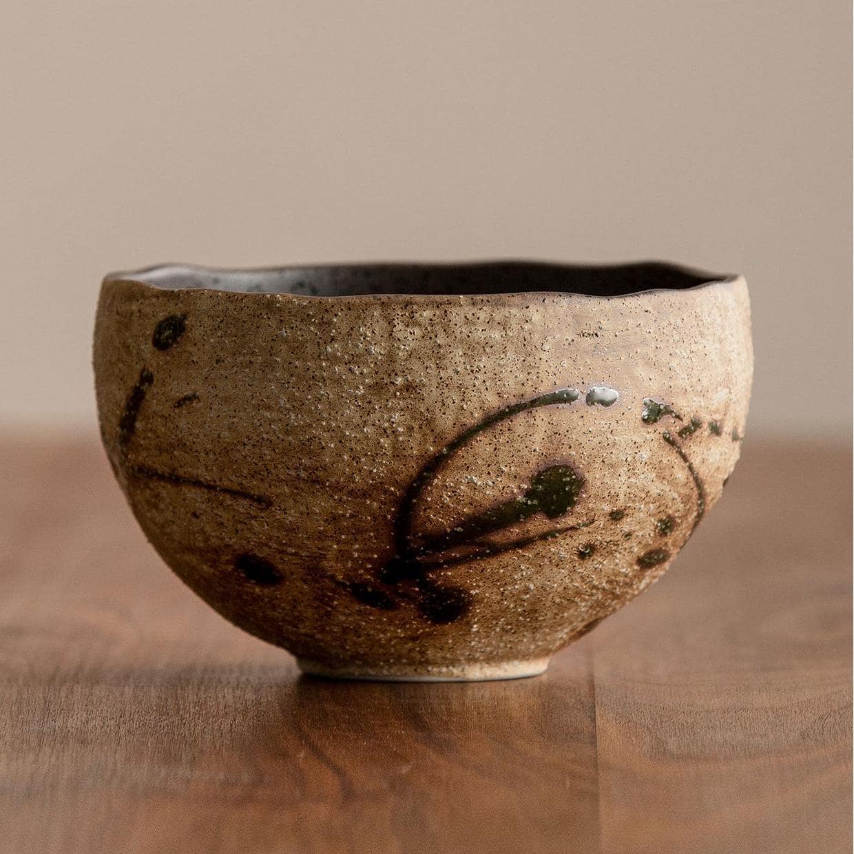 Rustic handmade ceramic bowl with earthy tones.