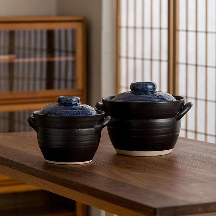 Japanese double-lid clay pot with black and blue glaze design.