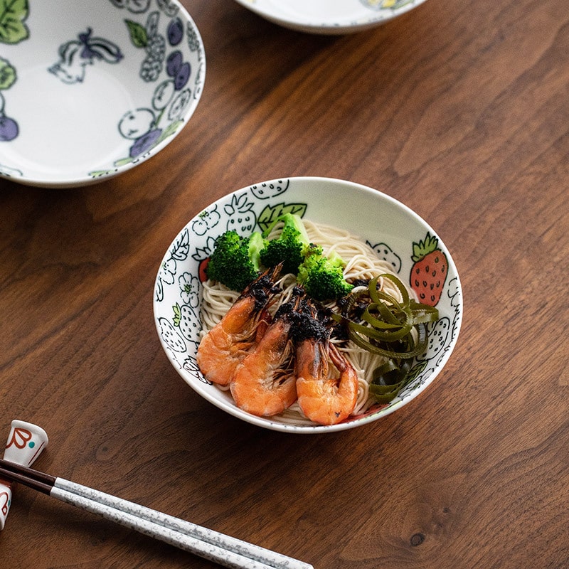 Close-up of hand-painted bowl featuring colorful designs