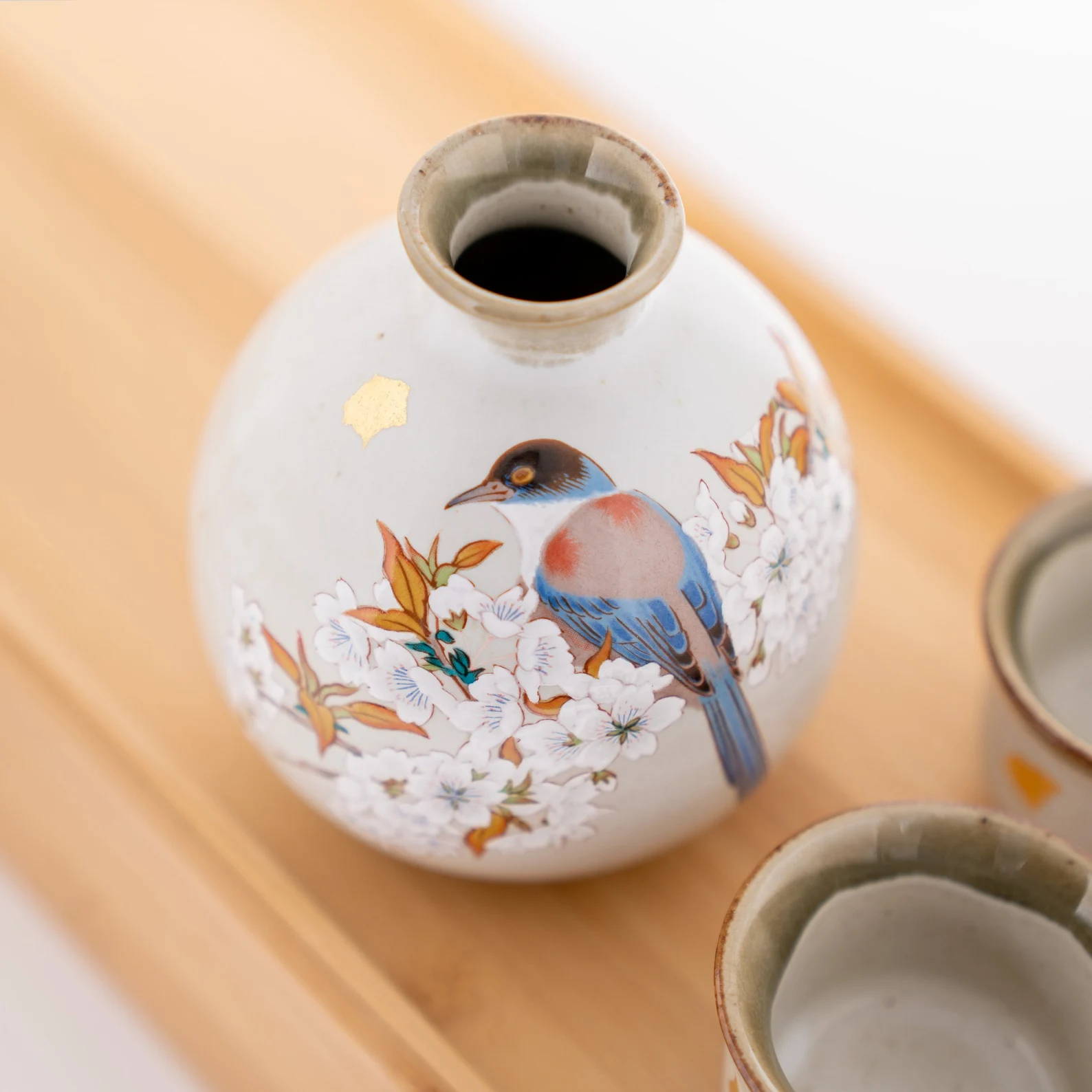 Handcrafted sake drinking set on a wooden surface