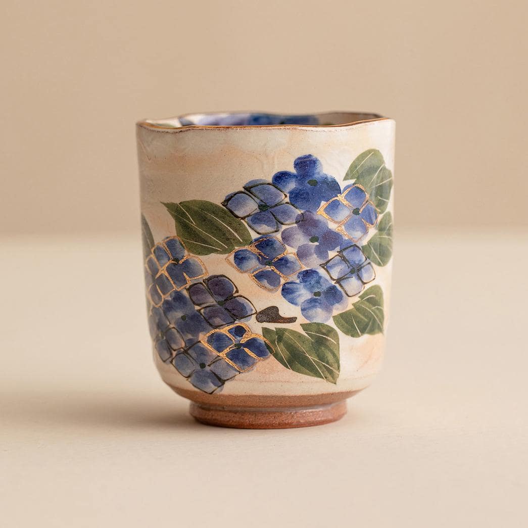 Close-up of artistic blue hydrangea design on a ceramic cup.