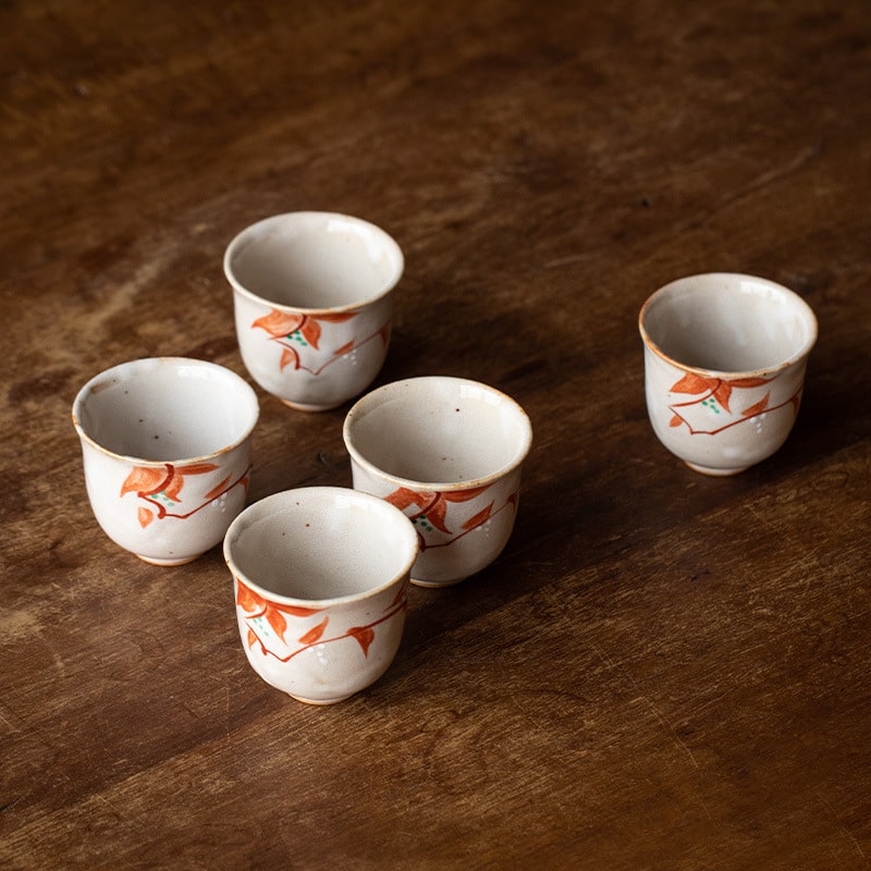 Set of five Japanese ceramic cups with hand-painted patterns