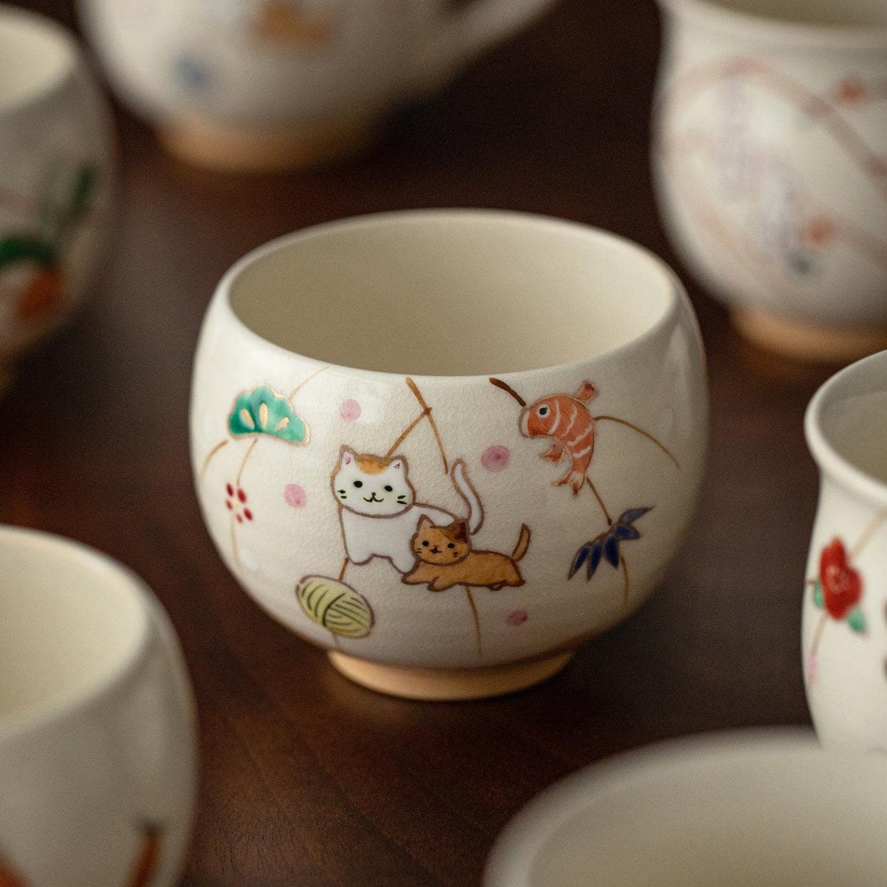 Close-up of a ceramic cup featuring vibrant sunflowers and summer scenes.