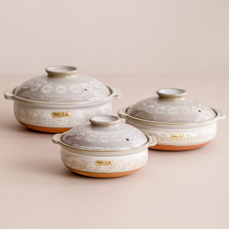 Japanese ceramic pots with embossed daisy patterns