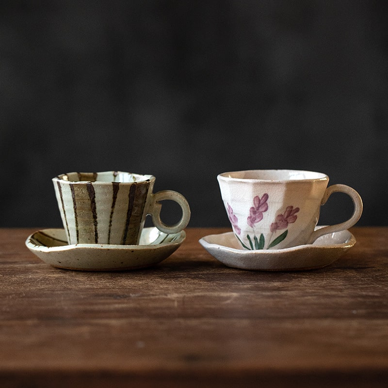 Durable ceramic coffee cup and saucer set on a wooden table.