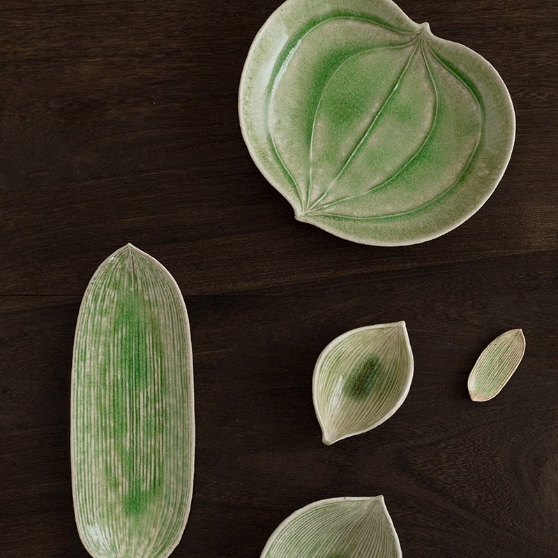 Leaf-shaped ceramic plates with green glaze and intricate texture