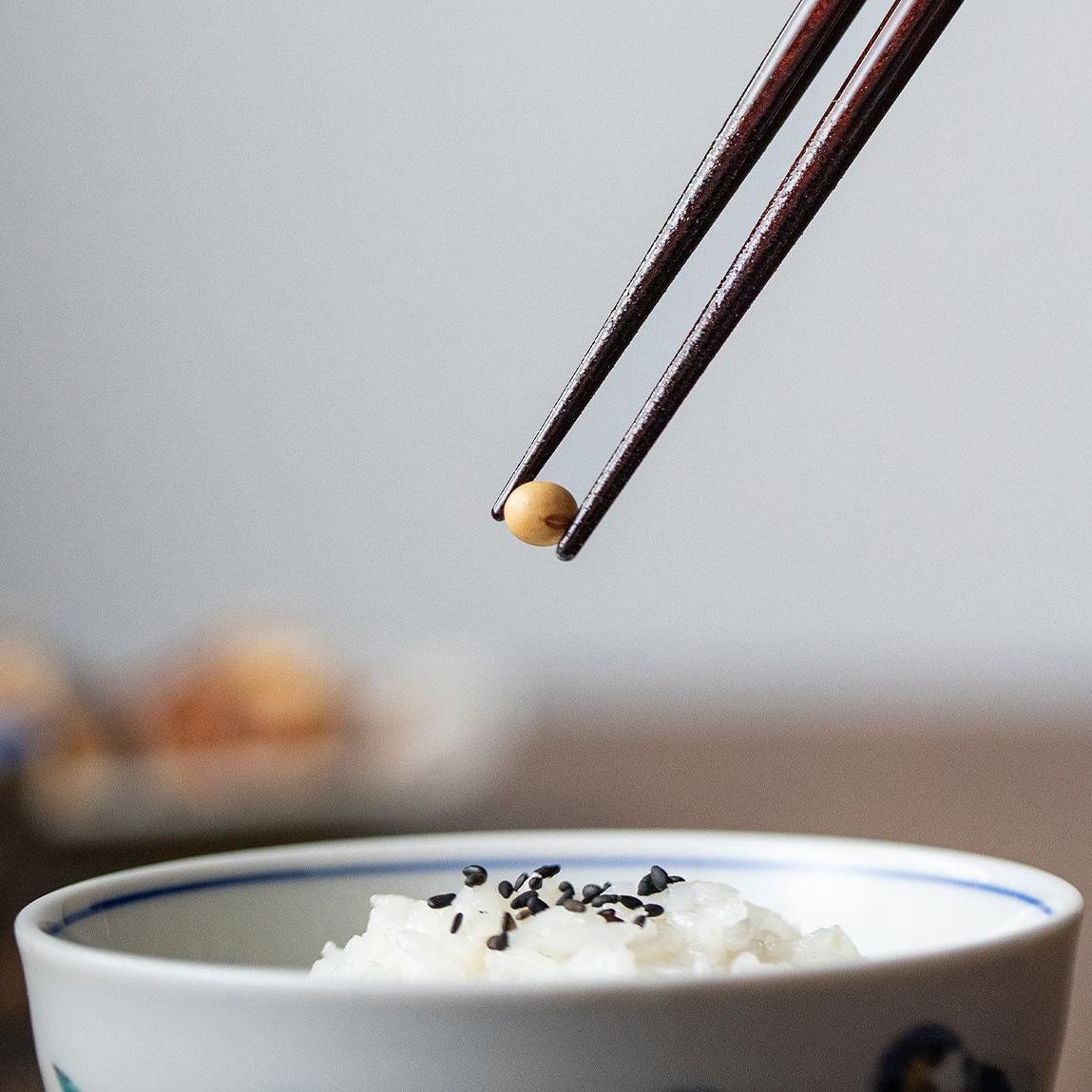 Close-up of elegant wooden chopsticks with gold patterns