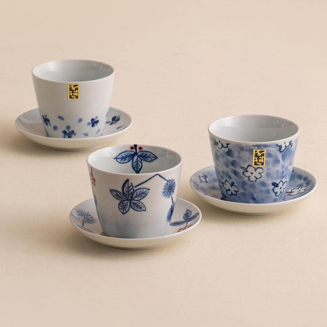 Blue floral porcelain cup with matching saucer on wooden tray