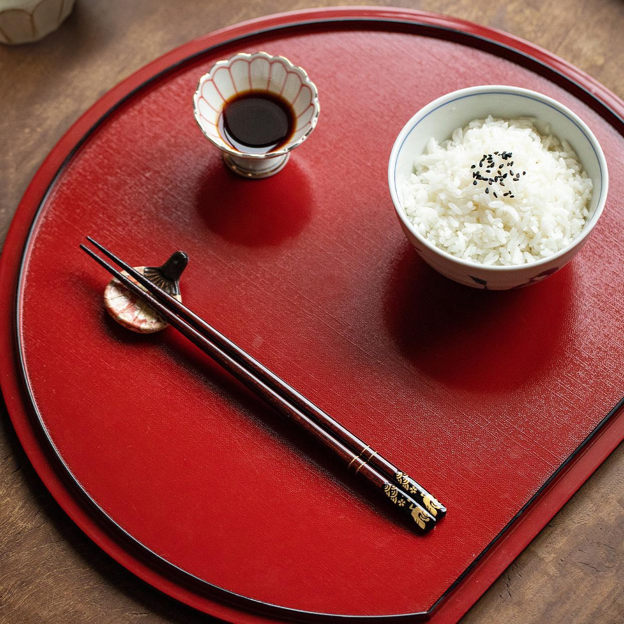 Close-up of elegant wooden chopsticks with gold patterns