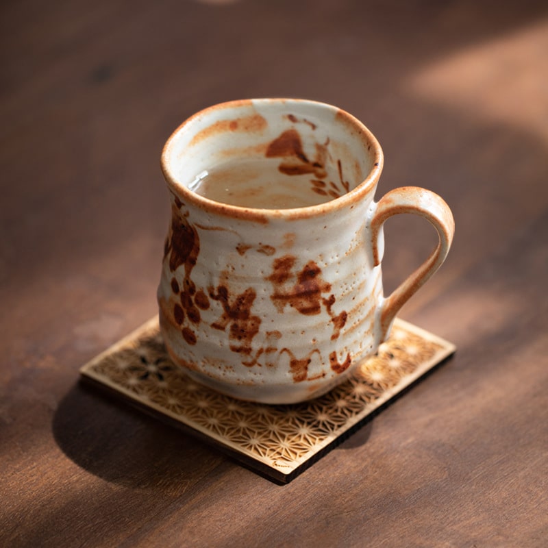 Rustic handcrafted ceramic mug with unique patterns