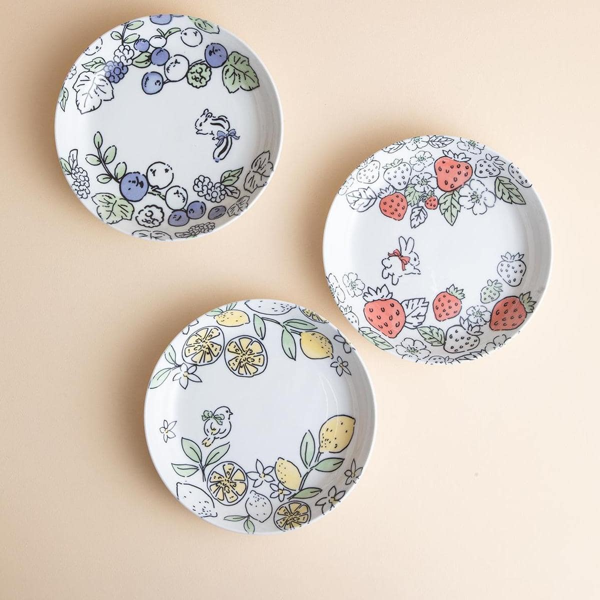 Whimsical Japanese porcelain bowls with fruit and animal motifs