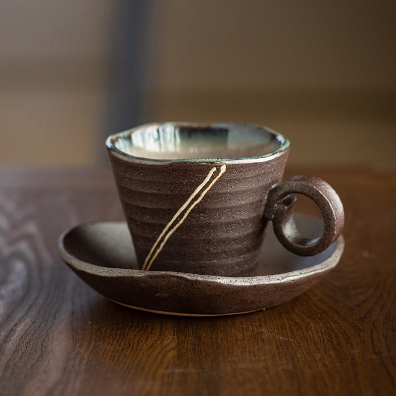 Artistic handcrafted ceramic tea cup with saucer.