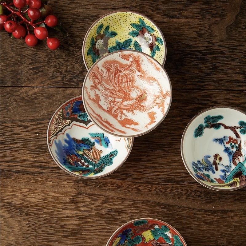 Wooden gift box containing five intricate hand-painted tea cups.
