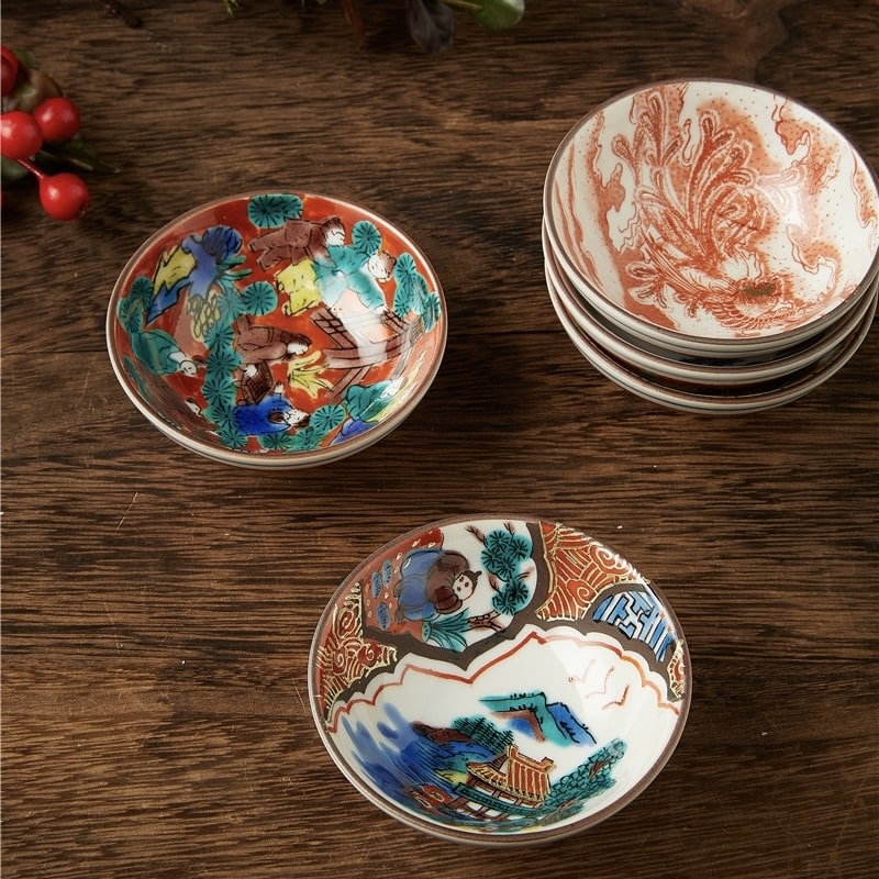 Wooden gift box containing five intricate hand-painted tea cups.
