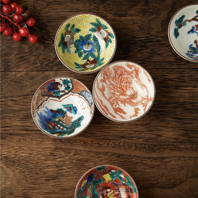 Japanese ceramic tea cups displayed with artistic detailing.
