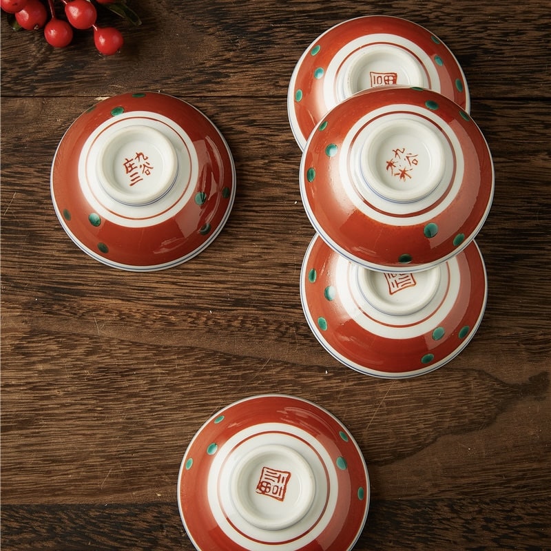 Japanese ceramic tea cups displayed with artistic detailing.
