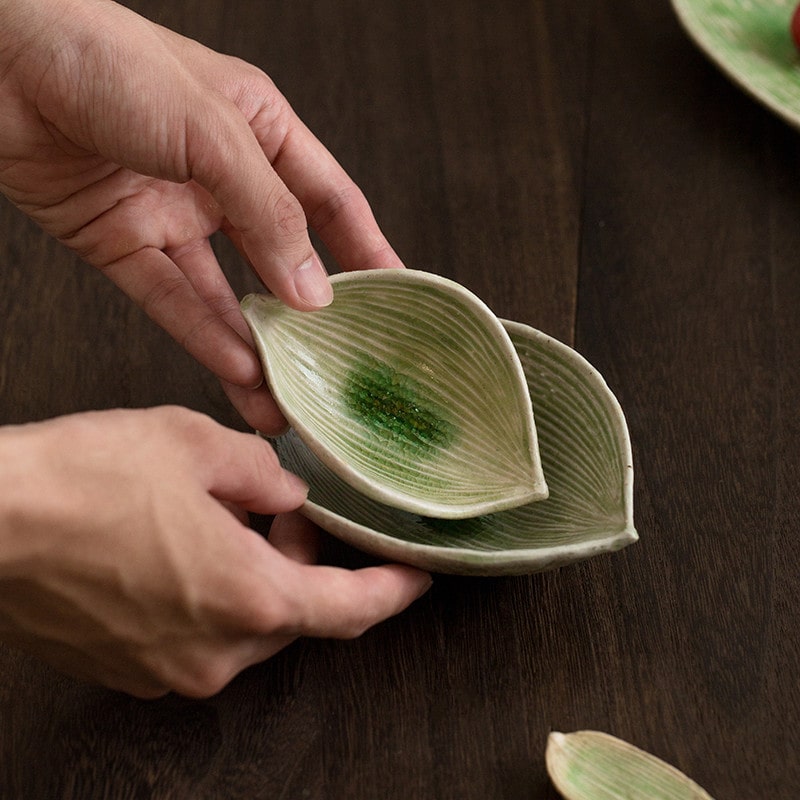 Artistic green ceramic plate with cherries, perfect for serving