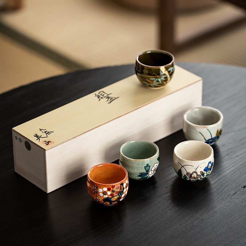 Handcrafted sake cups with nature-inspired designs.