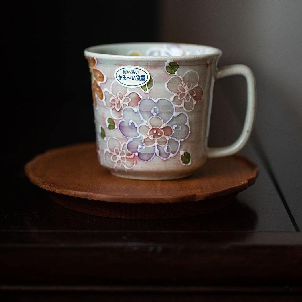 Close-up of ceramic mug showcasing hand-painted flowers