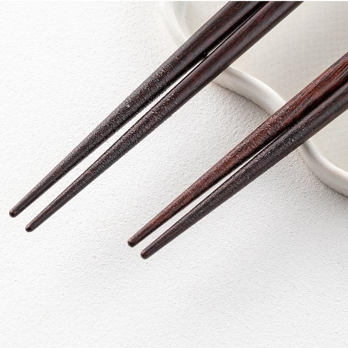 Close-up of artistic fish-patterned wooden chopsticks