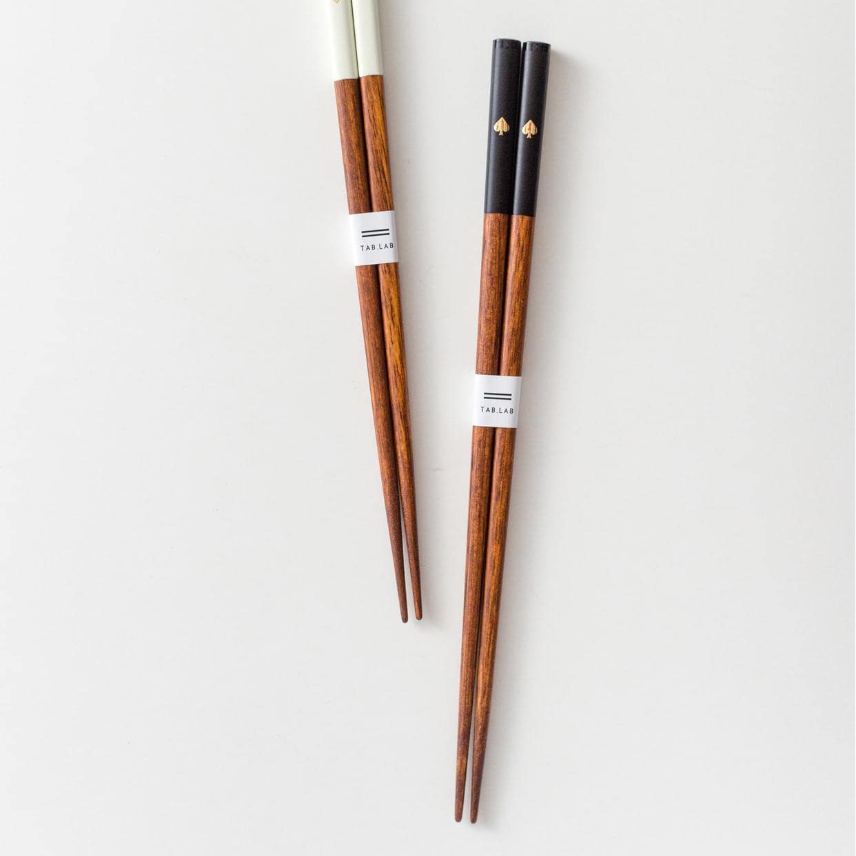 Wooden chopsticks with gold heart details and a matching rest