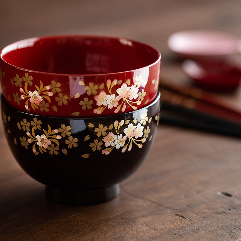 Close-up of red and black cherry blossom lacquerware bowls