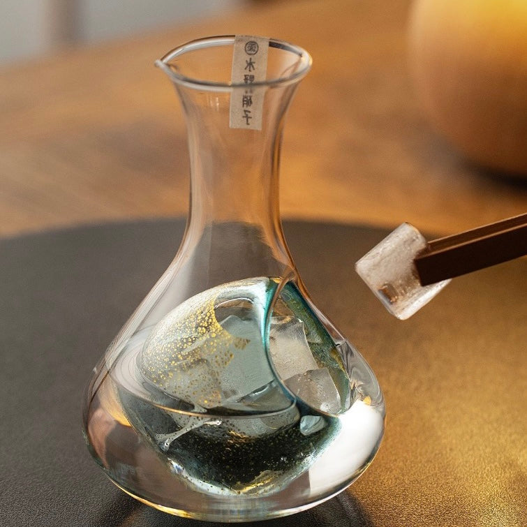 Close-up of the glass sake carafe’s elegant design.