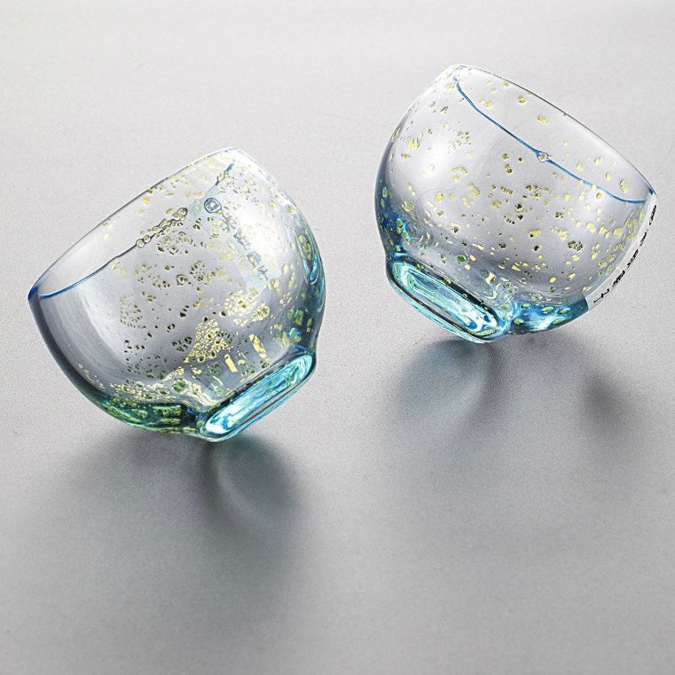 Transparent sake cups showcasing their rounded shape.