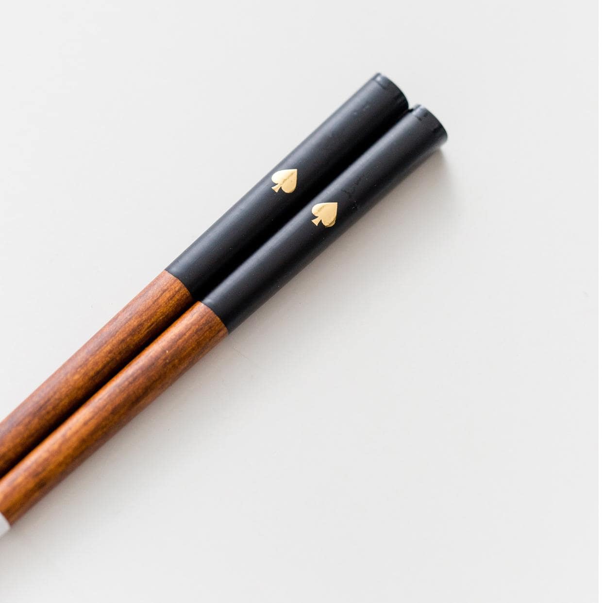 Black and white chopsticks with gold accents displayed on a table