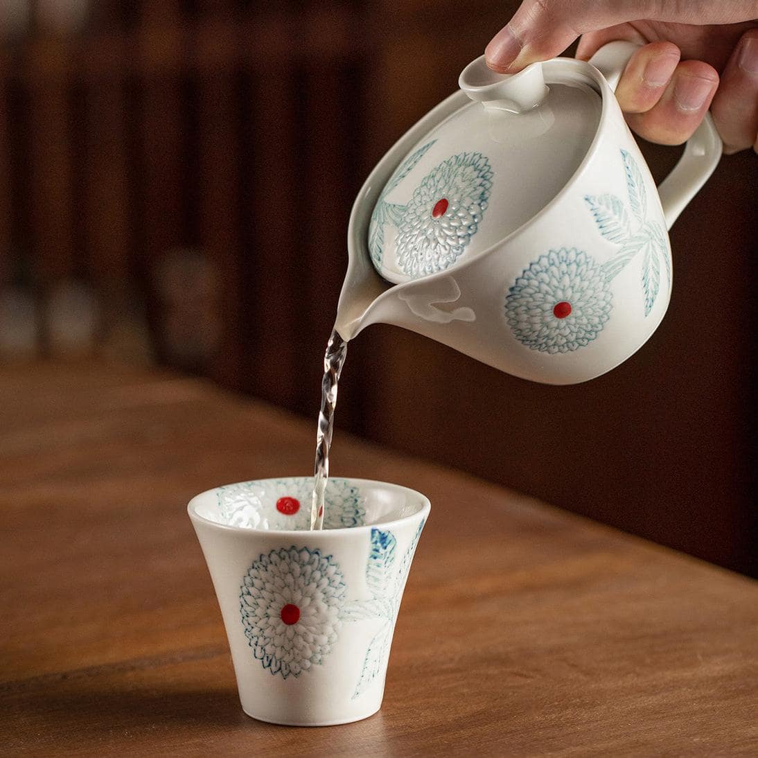 Handmade Japanese ceramic tea set with floral design.