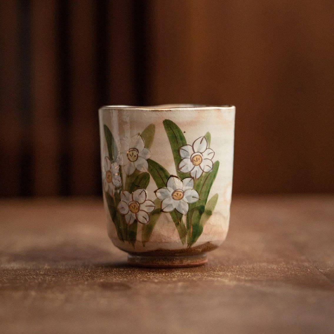 Close-up of artistic blue hydrangea design on a ceramic cup.