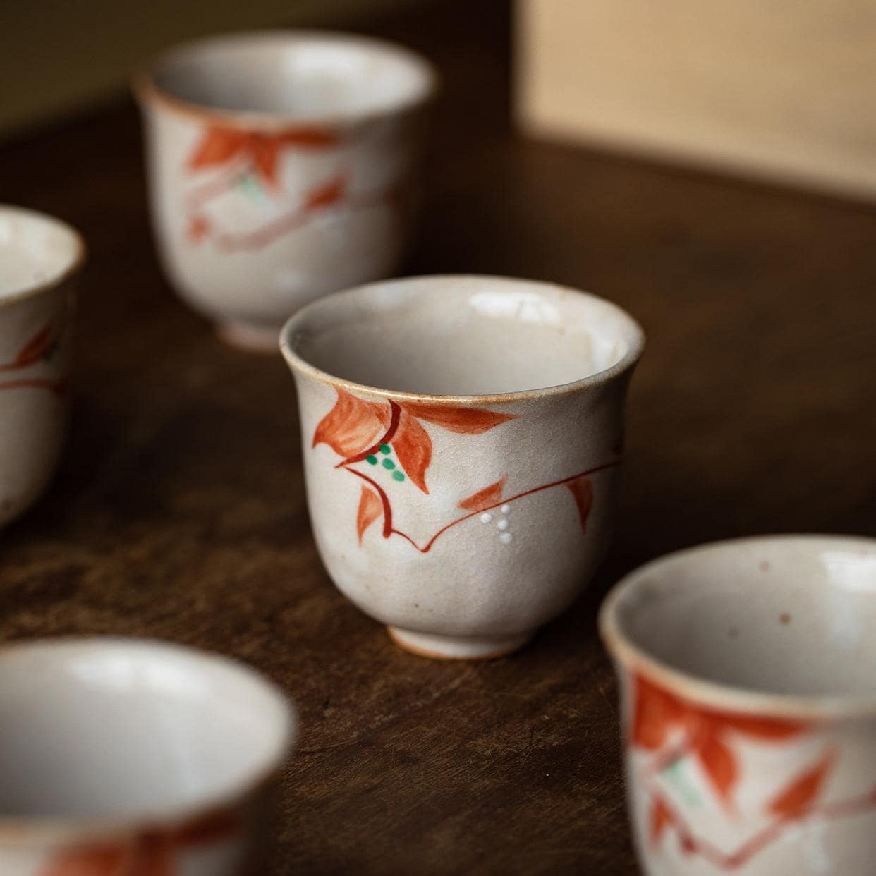 Set of five Japanese ceramic cups with hand-painted patterns