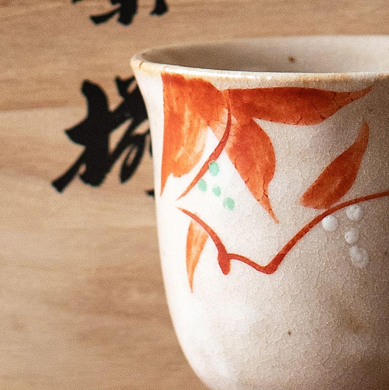 Close-up of hand-painted floral design on ceramic tea cup