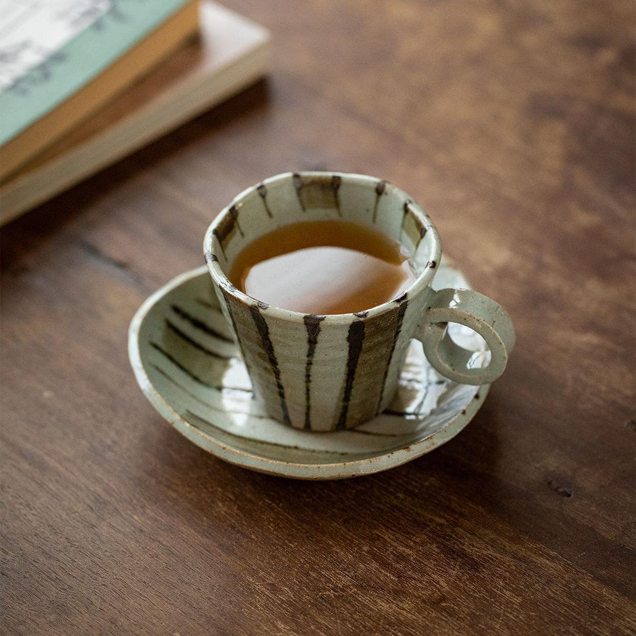 Elegant floral ceramic tea cup with crackle glaze finish.