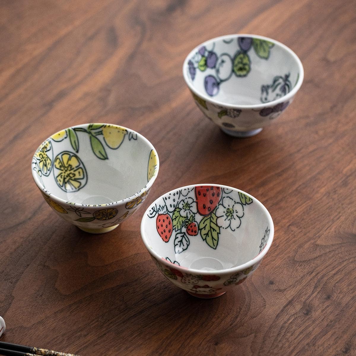 Whimsical Japanese porcelain bowls with fruit and animal motifs