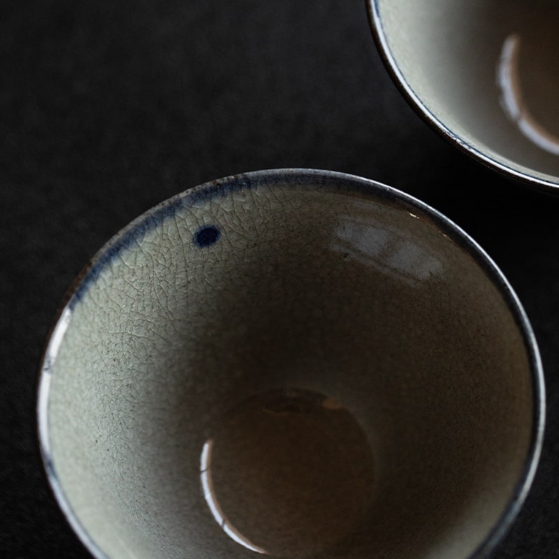 Two hand-painted ceramic bowls with black and white dogs