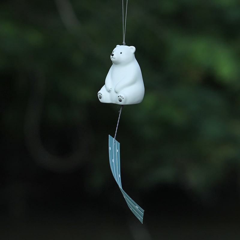 Pair of ceramic birds atop a Pharmacist Kiln wind chime.