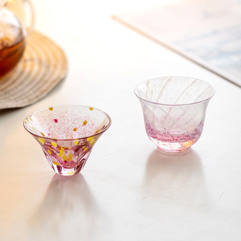 Pink and yellow speckled glass cup paired with light-reflective designs