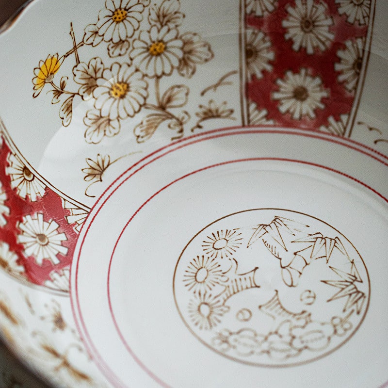 Scalloped edge ceramic plate with Japanese floral details