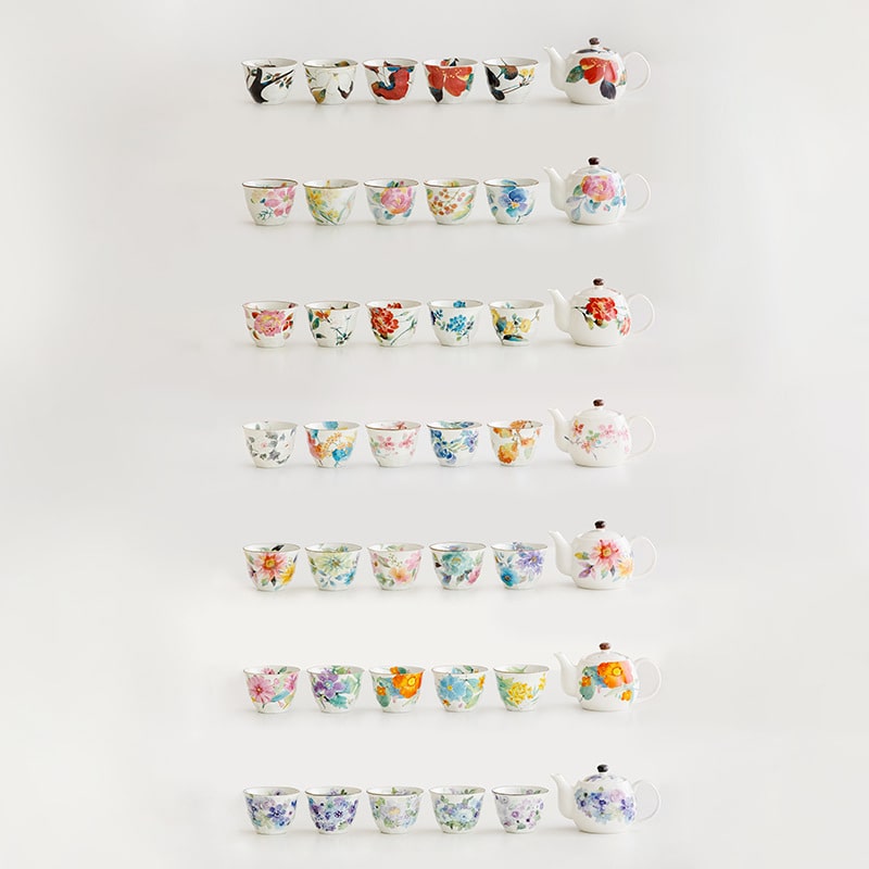 Collection of hand-painted floral teapot sets with cups