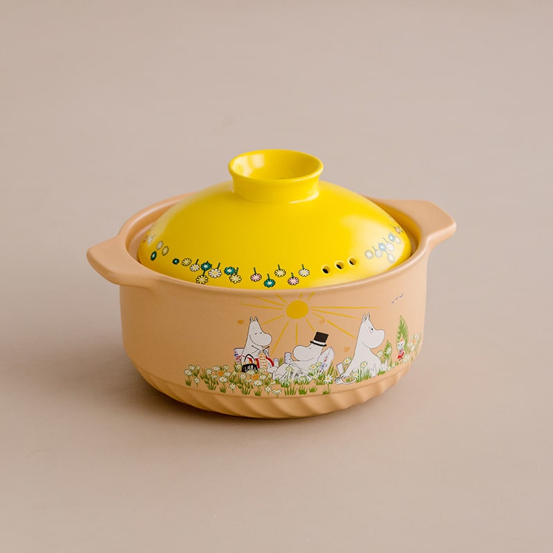 Close-up of Moomin ceramic pot with vibrant yellow lid.