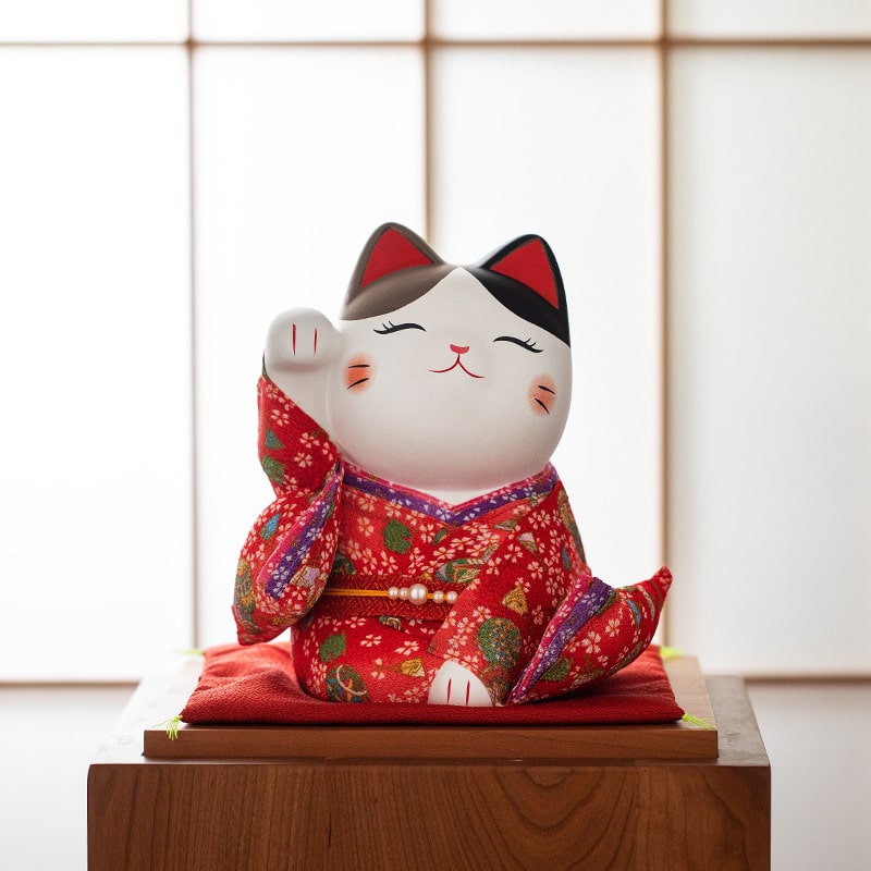 Japanese-style lucky cat with raised paw for good fortune