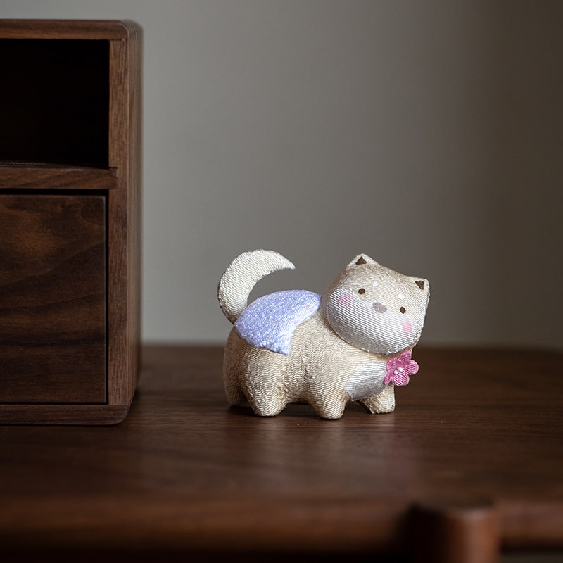 Light-colored lucky cat with angel wings on display