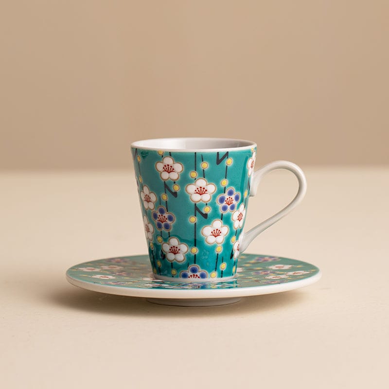 Artistic floral porcelain cup and matching saucer