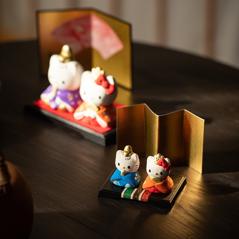 Decorative Hello Kitty couple ornaments on a wooden desk